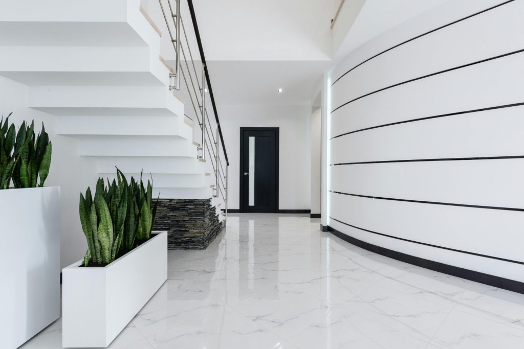 A contemporary and elegant interior featuring a stylish staircase and sleek design elements.